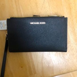 Brand new Michael Kors wallet/wristlet comes with a place to hold your phone